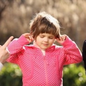 a child plugging their ears