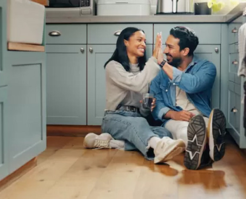 A couple in the kitchen on the floor