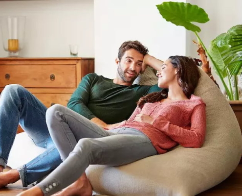 a couple chatting on a beanbag