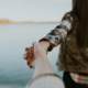 a woman leading a man by the hand